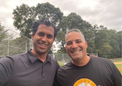 Vin Gopal with a supporter at a baseball field