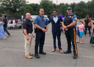Vin Gopal posing with police officers