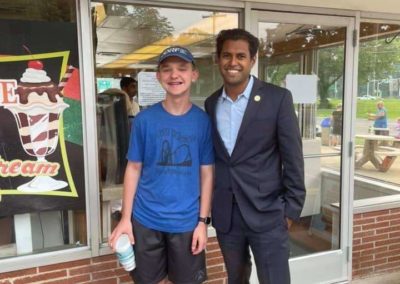 Vin Gopal standing outside an ice cream shop with a teenage boy.