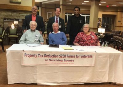 Vin Gopal with people helping veterans file for tax deductions.