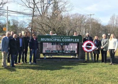 A group photo with the Township of Ocean Municipal Complex sign.